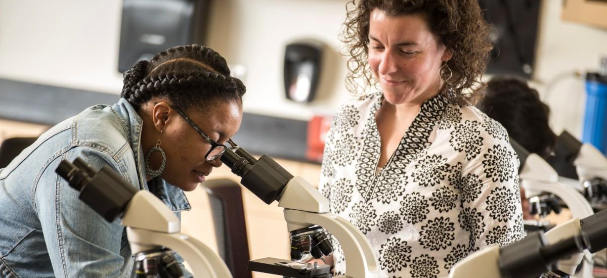 student, teacher and microscope